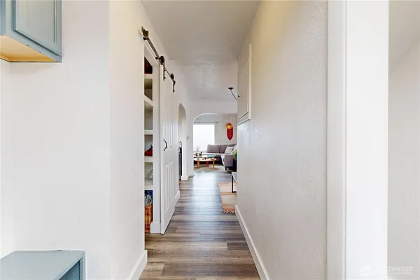 a view of a hallway with wooden floor