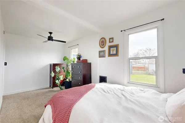 a bedroom with a bed and a window