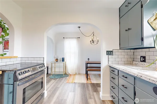 a kitchen with a stove oven and sink