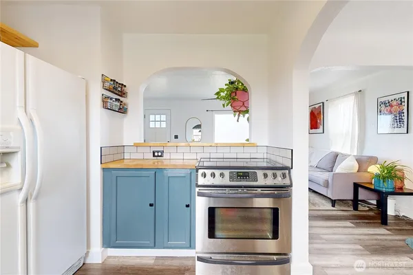 a kitchen with stainless steel appliances granite countertop a stove and a refrigerator