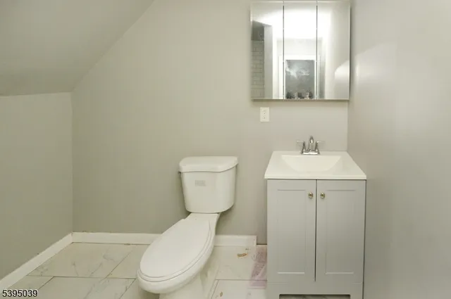a white toilet sitting next to a bathroom sink