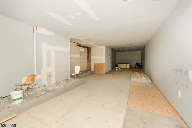 a view of a livingroom with furniture and a bedroom