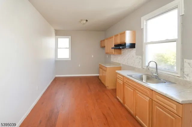 a kitchen with sink and window