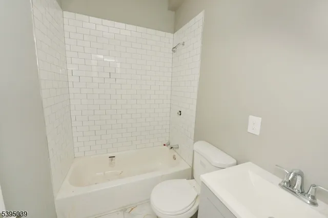 a bathroom with a toilet and a bathtub