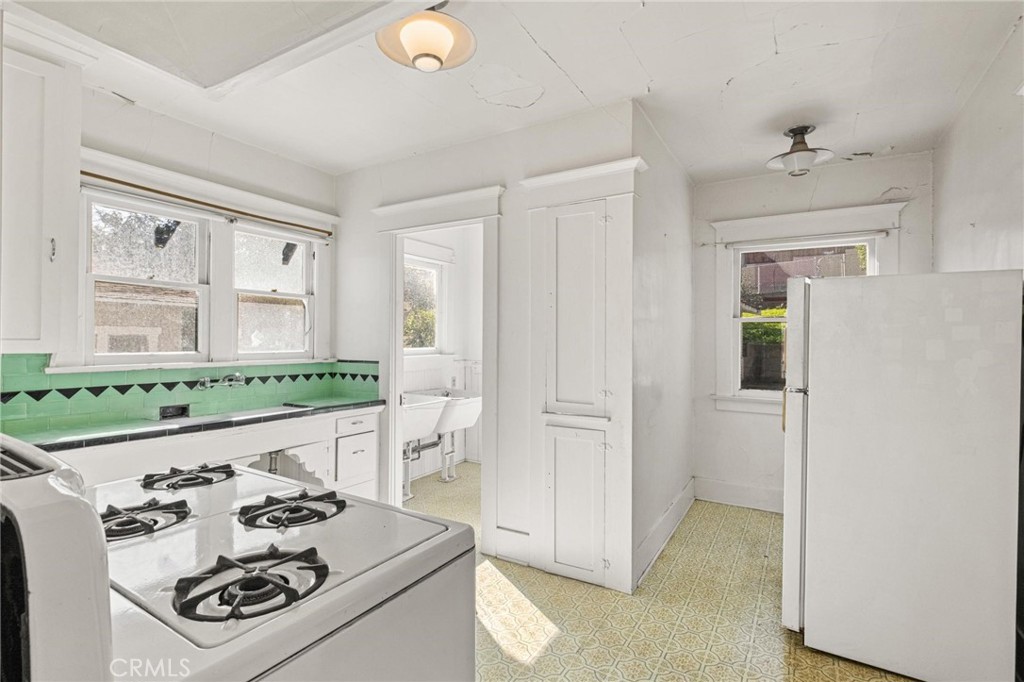 659 West 3rd Street San Pedro, CA 90731 - Photo 12 of 38 a kitchen with stainless steel appliances granite countertop a refrigerator and a stove