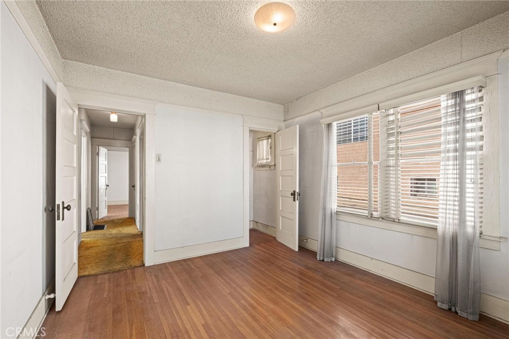 659 West 3rd Street San Pedro, CA 90731 - Photo 21 of 38 an empty room with wooden floor and windows