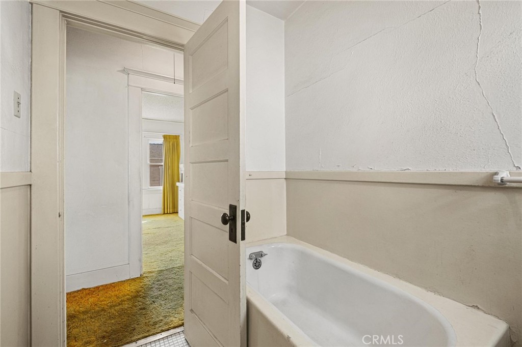 659 West 3rd Street San Pedro, CA 90731 - Photo 23 of 38 a bathroom with a tub and shower