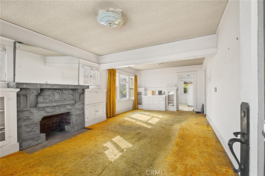 659 West 3rd Street San Pedro, CA 90731 - Photo 4 of 38 a spacious bedroom with a bed and a fireplace