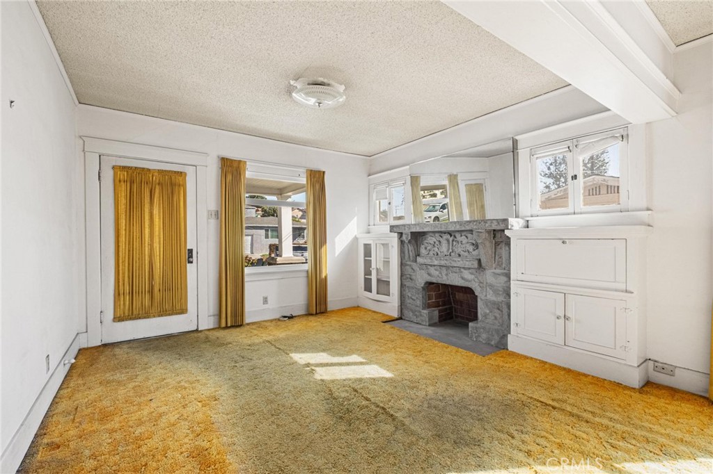 659 West 3rd Street San Pedro, CA 90731 - Photo 6 of 38 a view of a livingroom with a fireplace and window