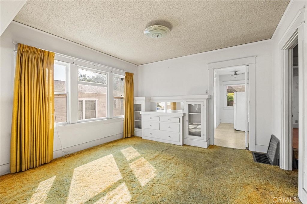 659 West 3rd Street San Pedro, CA 90731 - Photo 10 of 38 a view of a bedroom with furniture and windows