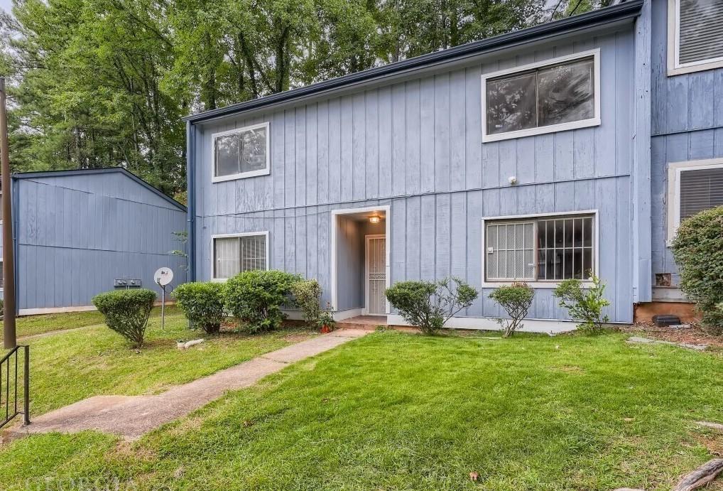 a front view of a house with garden and porch