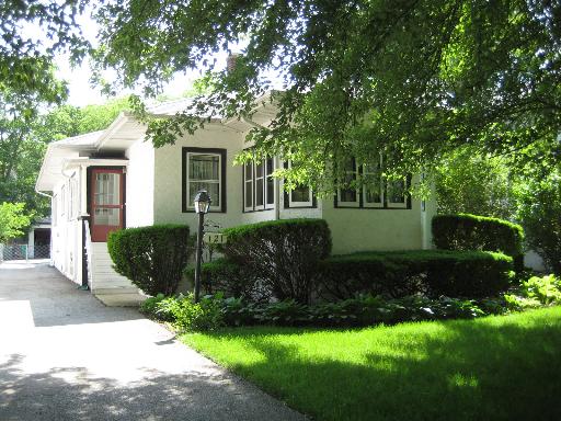 121 Woodside Road Riverside, IL 60546 - Photo 1 of 15 a front view of a house with a yard