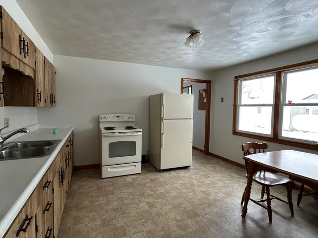 a kitchen with a stove a refrigerator and a sink