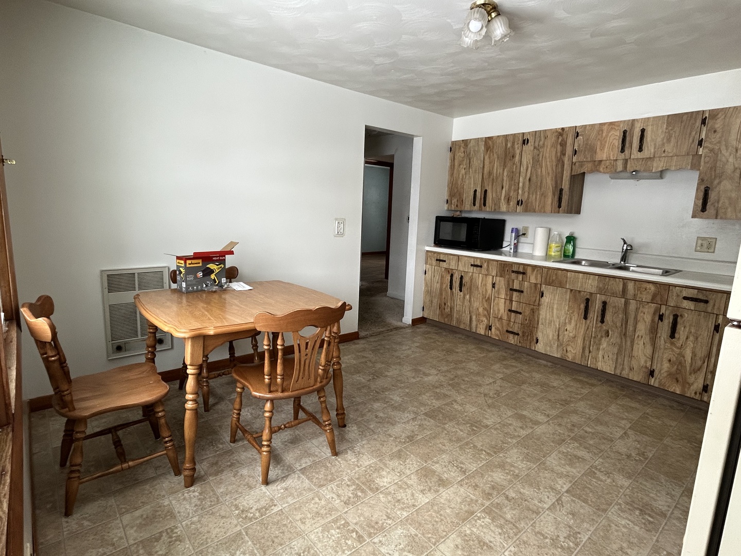 30368 Prairie Road Rock Falls, IL 61071 - Photo 4 of 10 a kitchen with a dining table chairs and a refrigerator