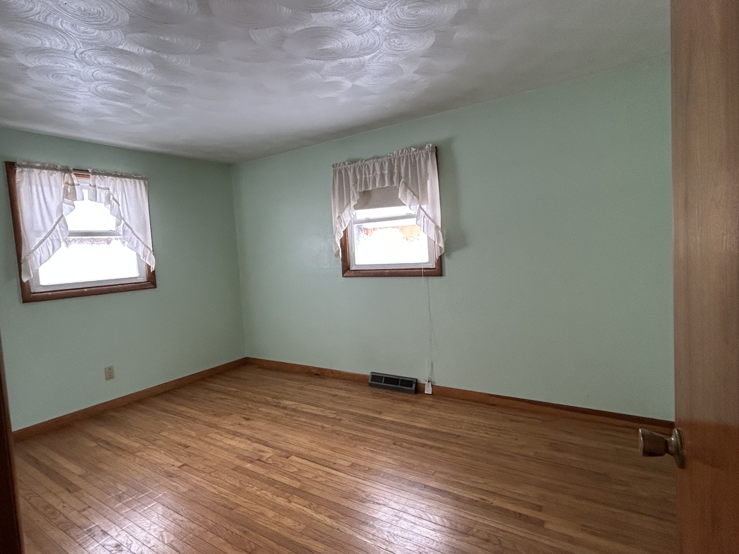 30368 Prairie Road Rock Falls, IL 61071 - Photo 8 of 10 an empty room with wooden floor and windows