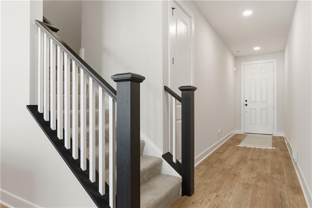 247 Limehouse Road Cranberry Township, PA 16066 - Photo 4 of 43 a view of a hallway with wooden floor and staircase