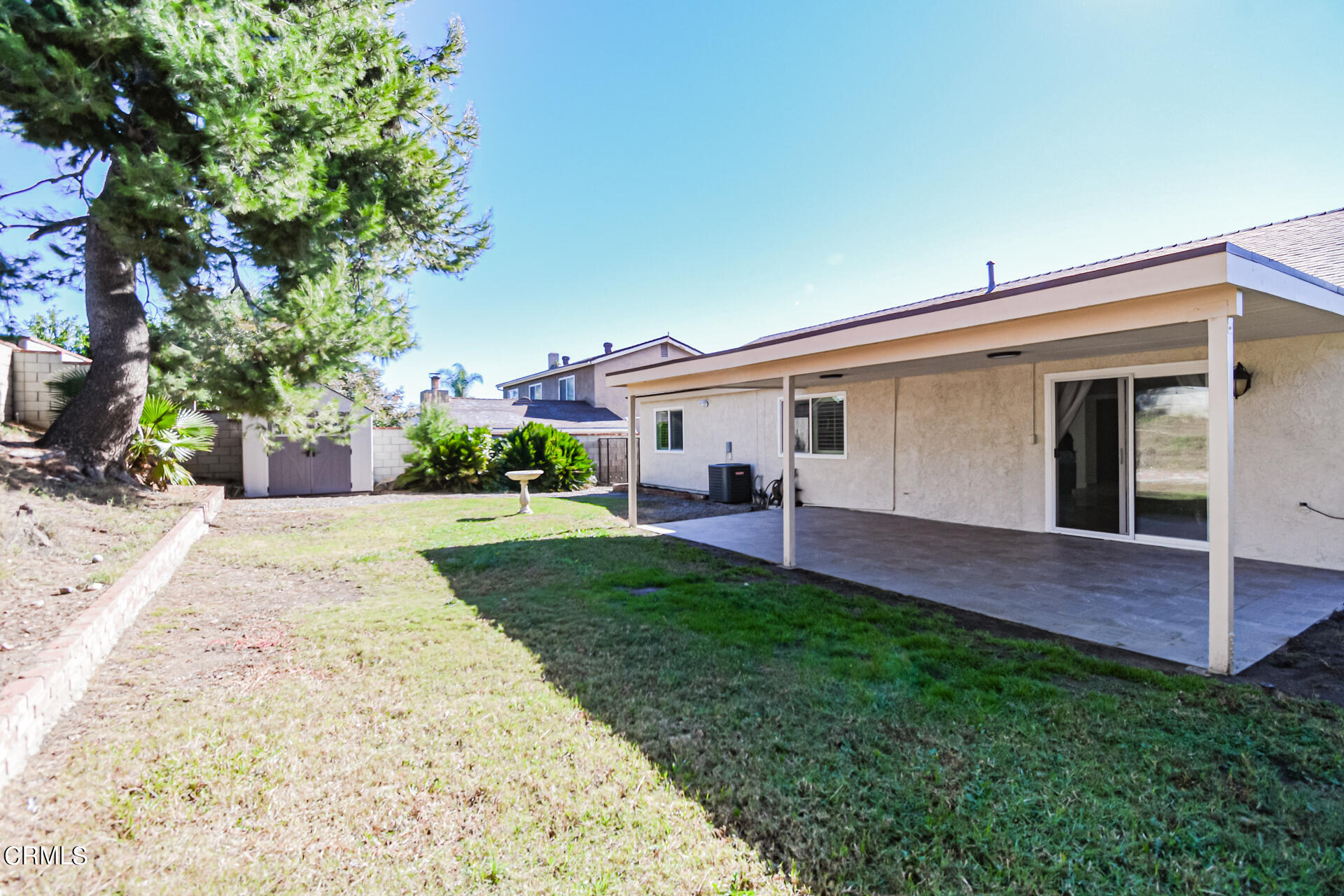 9310 Friant Street Rancho Cucamonga, CA 91730 - Photo 23 of 26 a view of a white house with a big yard plants and large tree