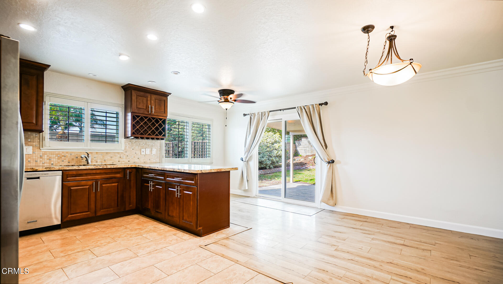 9310 Friant Street Rancho Cucamonga, CA 91730 - Photo 4 of 26 a large kitchen with stainless steel appliances granite countertop a stove and cabinets