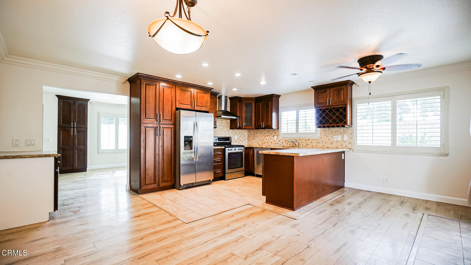 9310 Friant Street Rancho Cucamonga, CA 91730 - Photo 5 of 26 a kitchen with stainless steel appliances kitchen island granite countertop a refrigerator a stove a sink dishwasher and a oven with large countertops