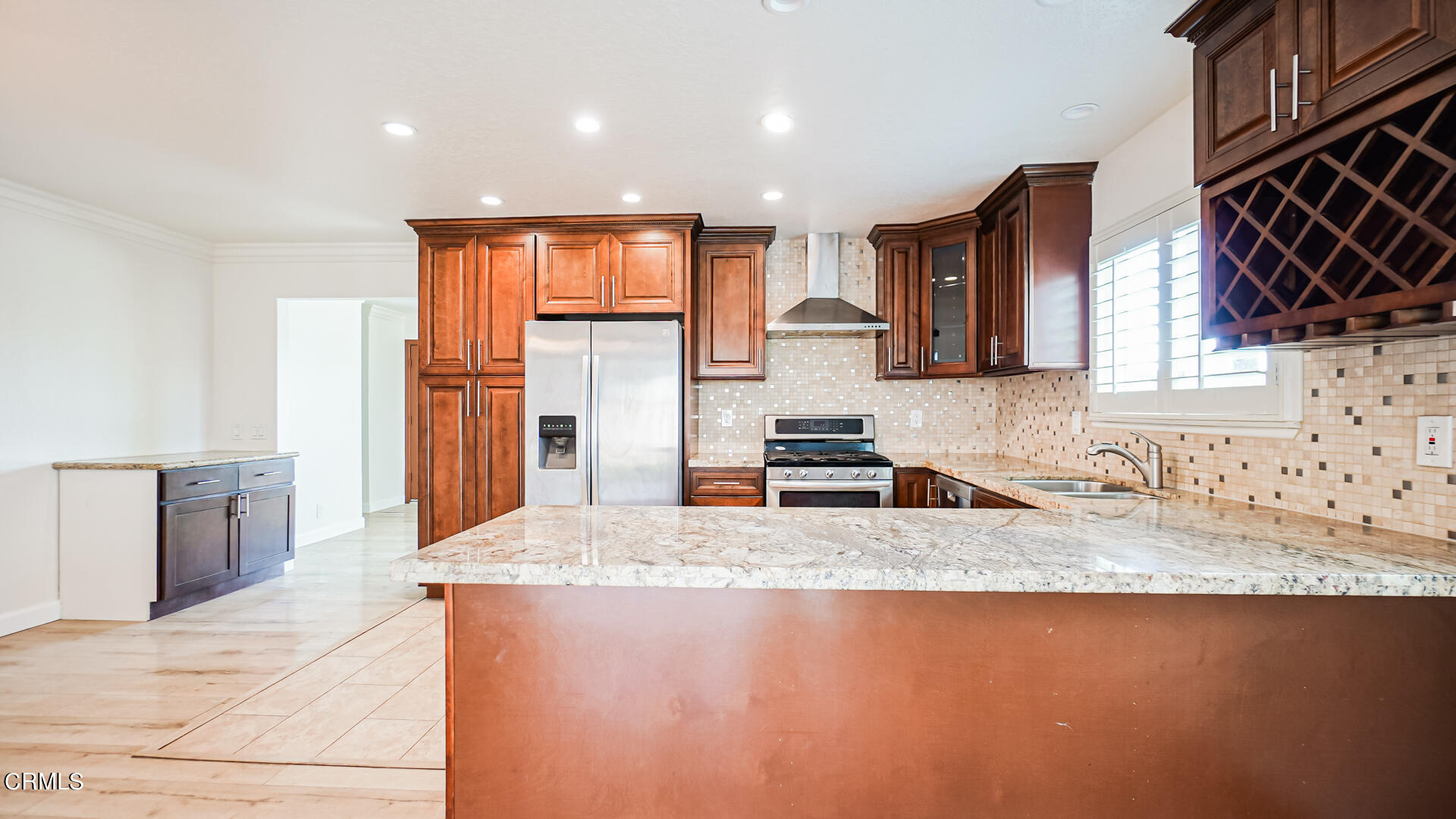 9310 Friant Street Rancho Cucamonga, CA 91730 - Photo 6 of 26 a kitchen with stainless steel appliances granite countertop a sink a stove and a refrigerator