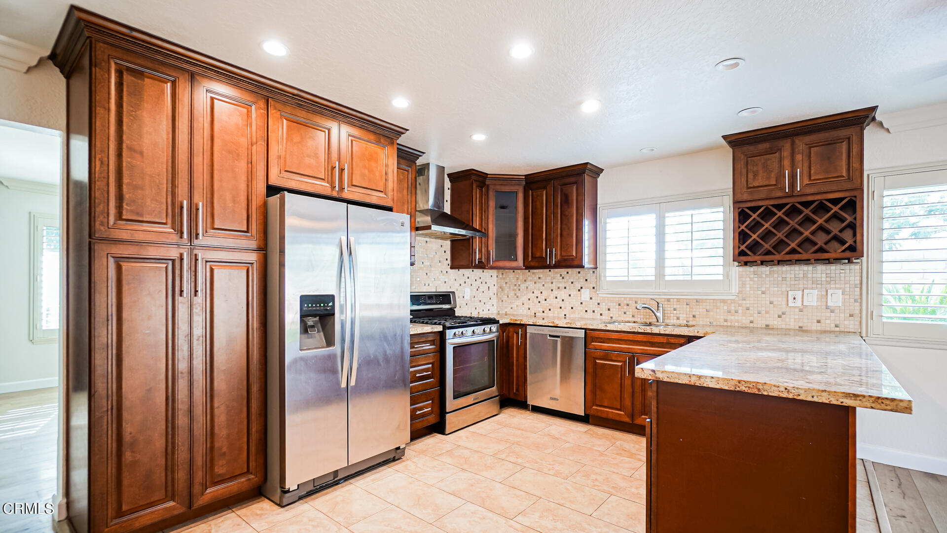 9310 Friant Street Rancho Cucamonga, CA 91730 - Photo 7 of 26 a kitchen with stainless steel appliances granite countertop a refrigerator and a sink