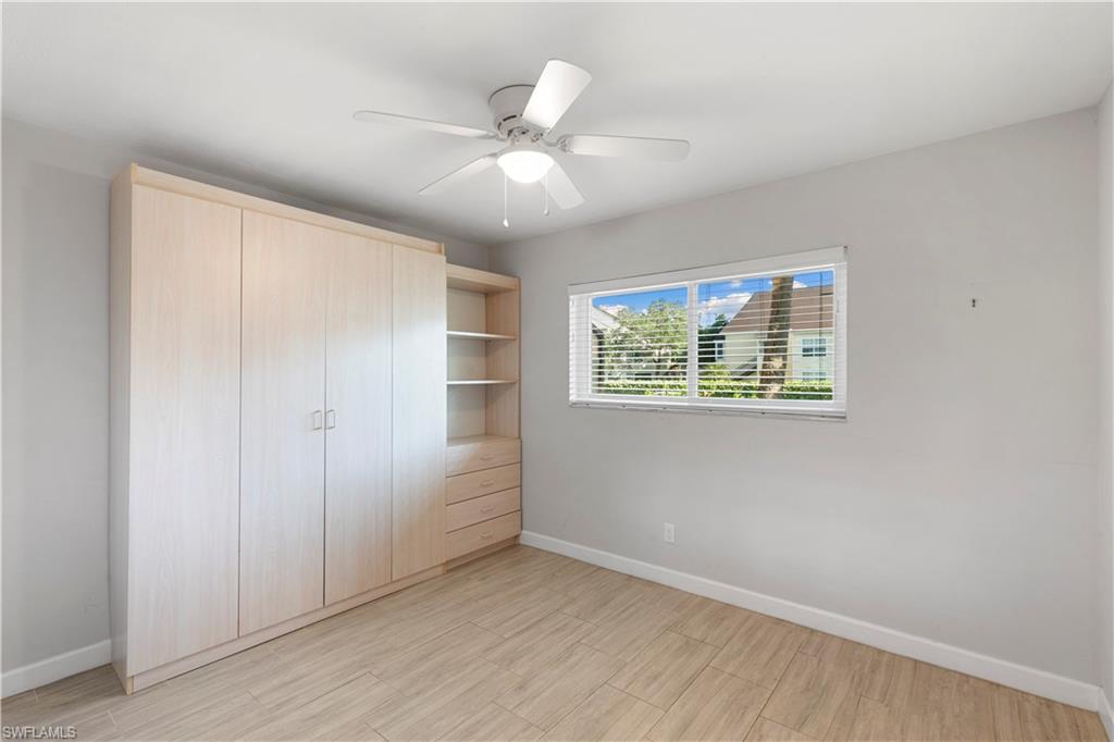 1008 Manatee Road, Unit G103 Naples, FL 34114 - Photo 12 of 24 an empty room with windows and fan