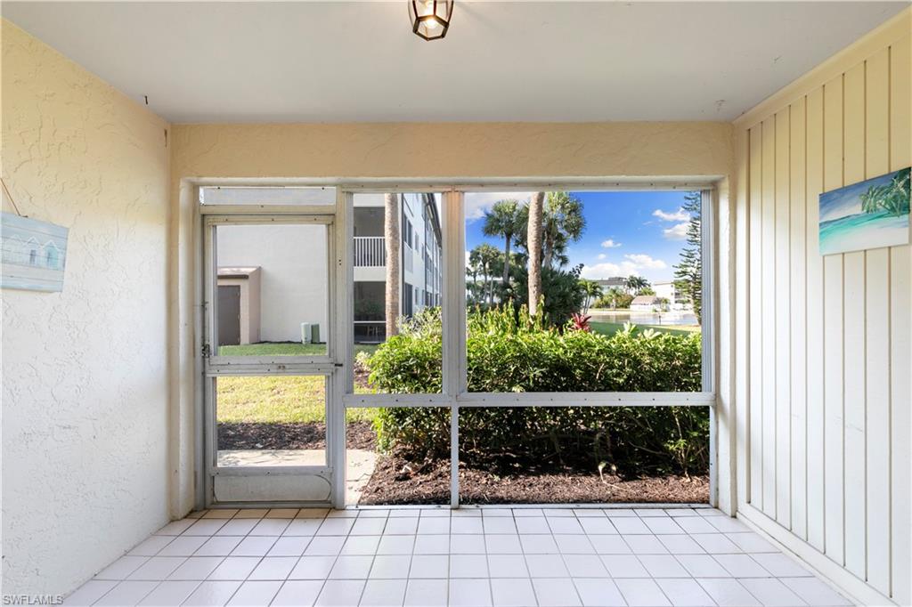 1008 Manatee Road, Unit G103 Naples, FL 34114 - Photo 14 of 24 a view of a room that has a bed and a large window