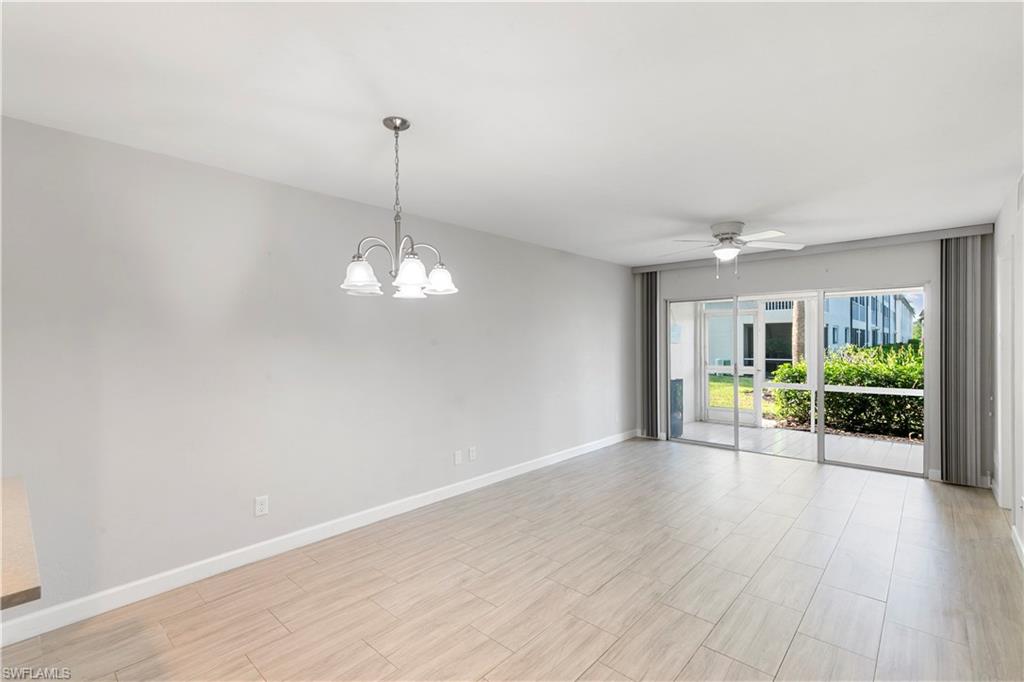 1008 Manatee Road, Unit G103 Naples, FL 34114 - Photo 2 of 24 a view of a room with wooden floor fireplace and window