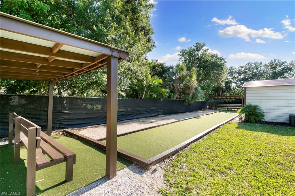 1008 Manatee Road, Unit G103 Naples, FL 34114 - Photo 24 of 24 a view of a backyard with a tub and trees