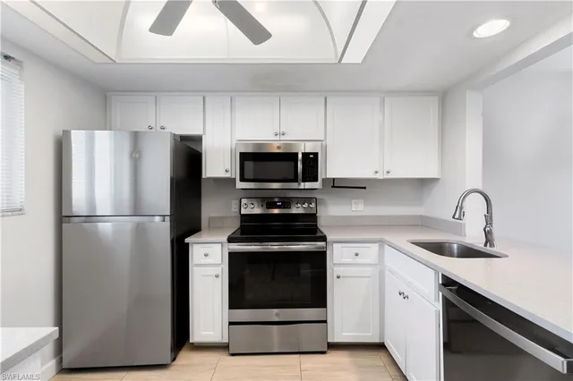 a kitchen with a stove sink and refrigerator