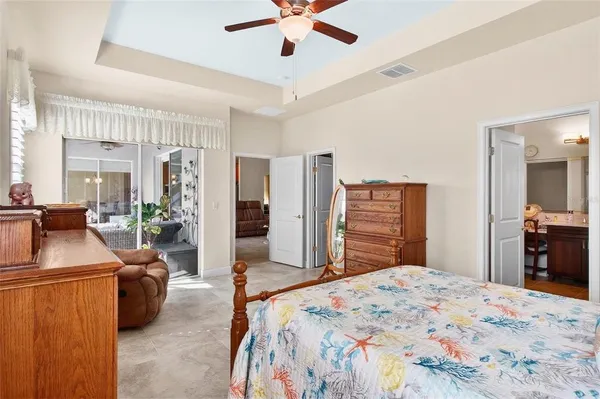 a bedroom with furniture and a large window