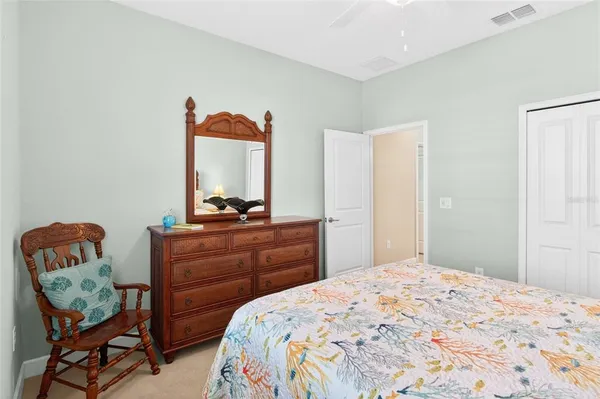 a bedroom with a bed and chair