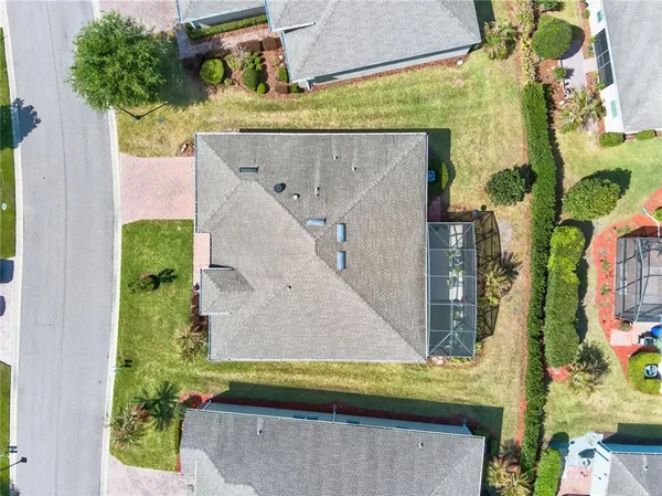 an aerial view of a residential houses with outdoor space