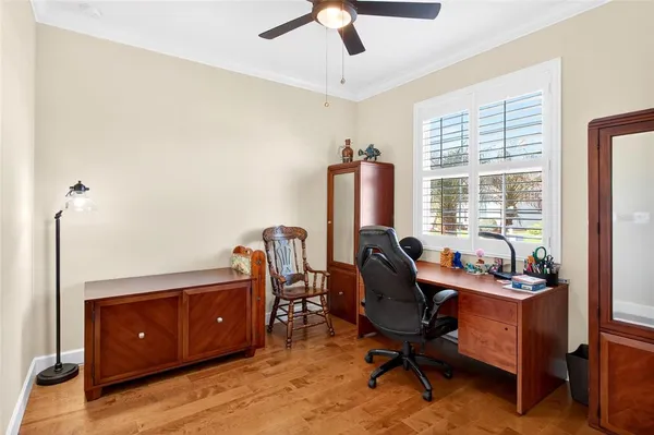 a view of a workspace with furniture and a window