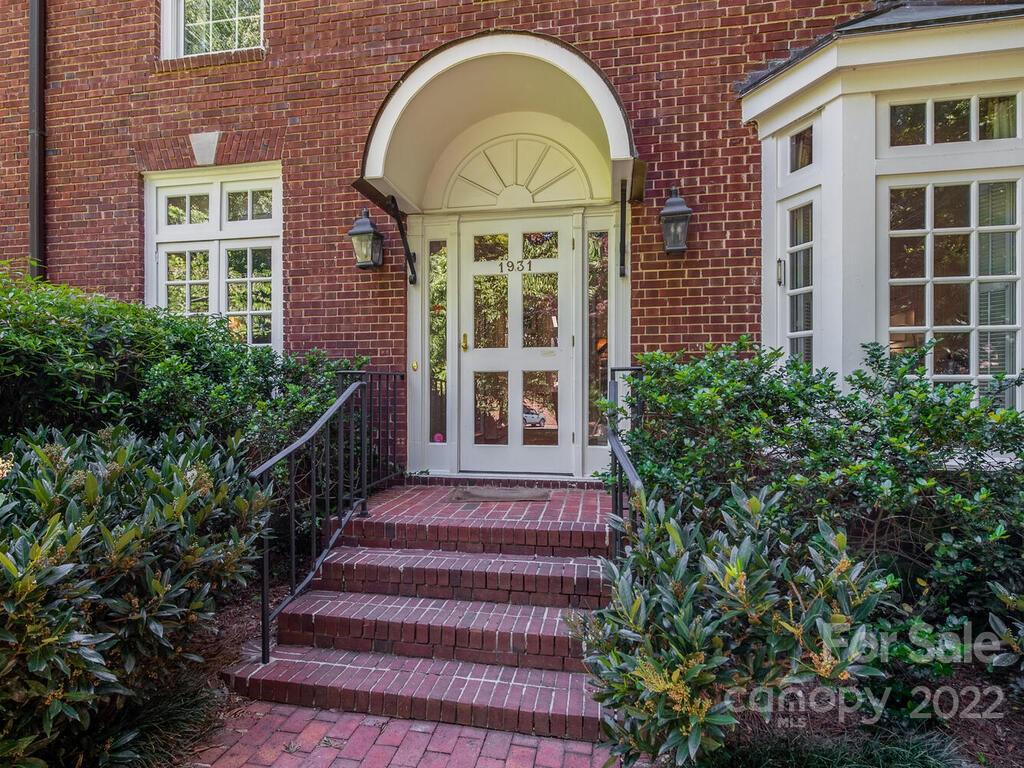 1931 Queens Road Charlotte, NC 28207 - Photo 1 of 23 a front view of a house with a garden