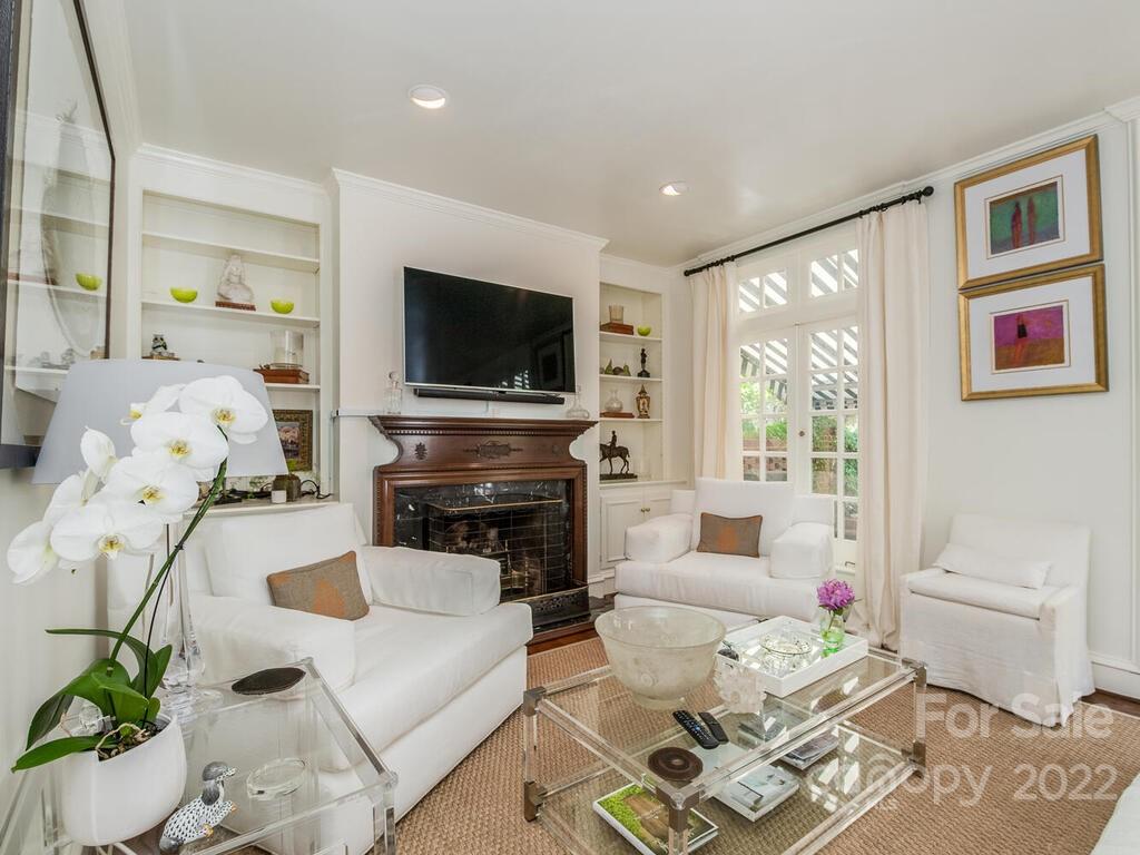 1931 Queens Road Charlotte, NC 28207 - Photo 11 of 23 a living room with furniture a flat screen tv and a fireplace