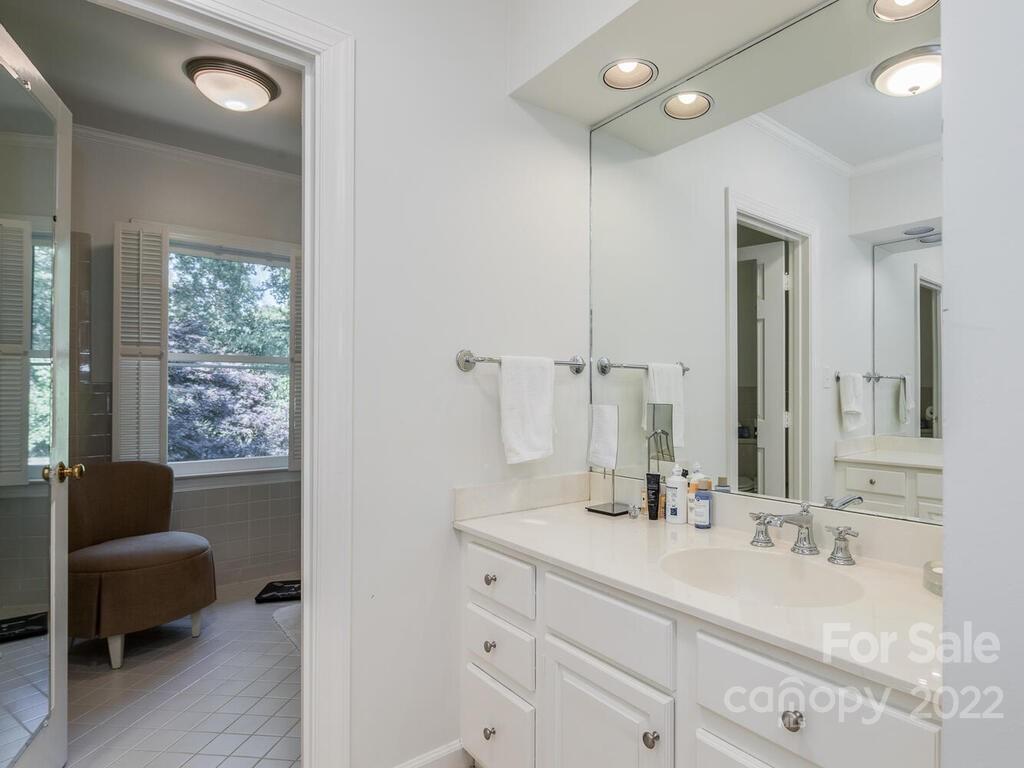 1931 Queens Road Charlotte, NC 28207 - Photo 16 of 23 a bathroom with a double vanity sink large mirror and bathtub