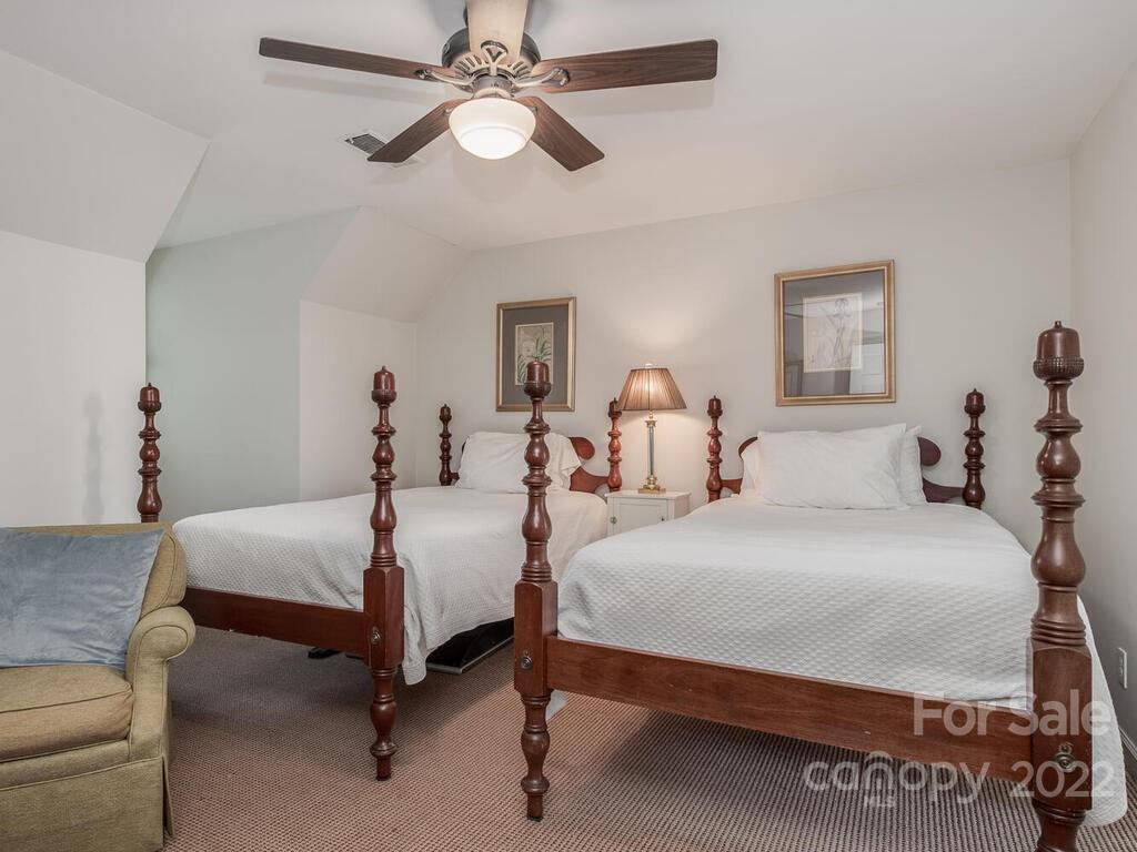 1931 Queens Road Charlotte, NC 28207 - Photo 19 of 23 a bedroom with bed and a chandelier