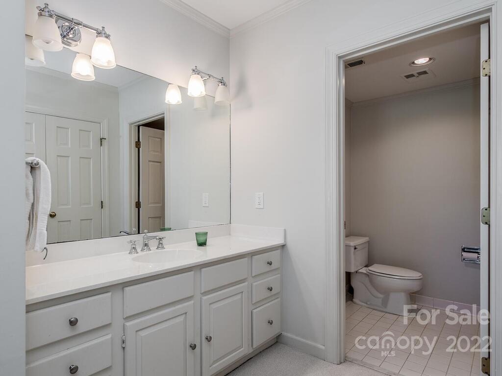 1931 Queens Road Charlotte, NC 28207 - Photo 20 of 23 a bathroom with a double vanity sink and a toilet