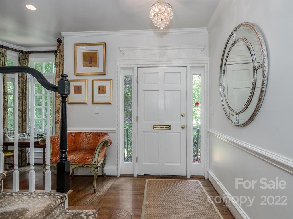 1931 Queens Road Charlotte, NC 28207 - Photo 5 of 23 a view of a livingroom with furniture and a mirror
