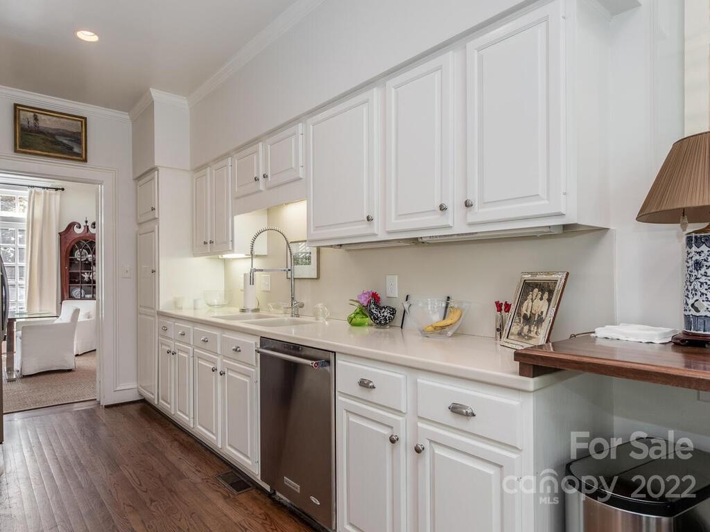 1931 Queens Road Charlotte, NC 28207 - Photo 7 of 23 a kitchen with white cabinets and sink