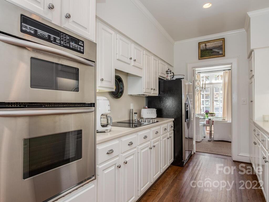 1931 Queens Road Charlotte, NC 28207 - Photo 8 of 23 a kitchen with cabinets and steel stainless steel appliances