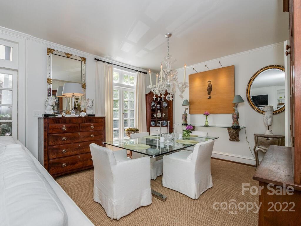 1931 Queens Road Charlotte, NC 28207 - Photo 9 of 23 a dining hall with couches a flat tv screen and a dining table with garden view