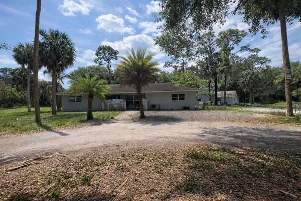 a front view of a house with a yard and a garage