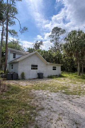 a house that has a tree in front of it