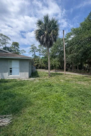a view of a house with a backyard