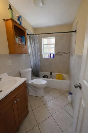 a bathroom with a sink a toilet and bathtub