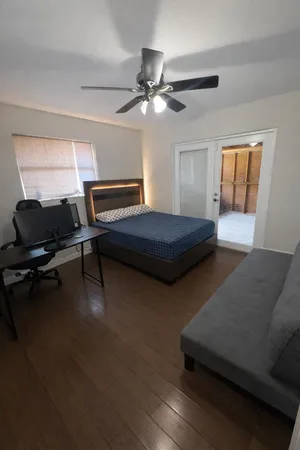a bedroom with furniture and a window