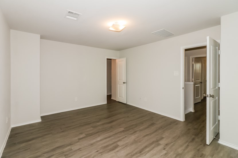 21626 Mamba Way Houston, TX 77073 - Photo 10 of 12 a view of an empty room with wooden floor and a window