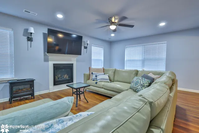 a view of a room with wooden floor and windows